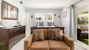 A bedroom with a bed, a dresser, a sofa, a ceiling fan, and a window with blinds. - Family Retreat w/ Dual Masters - Screened Pool, Media Game Room & Beach 6 Miles (Hollywood)