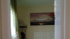A bedroom with a bed, a radiator, and a painting on the wall. - CASA CALA IGORA SPAIN (Torrevieja)