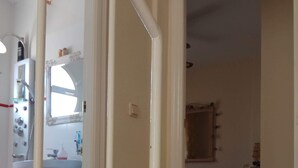 A bathroom with a toilet, sink, and mirror. - CASA CALA IGORA SPAIN (Torrevieja)
