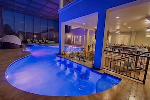 Relax by the pool surrounded by a deck and lounge chairs, with a covered seating area nearby.