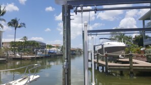 A marina with boats docked, a clear sky, and palm trees. - I'm the ONE! The CONCH Walk to Beach and Times Square (FMB)