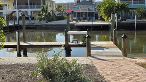 A waterfront property with a dock, a covered seating area, and a view of the water. - I'm the ONE! The CONCH Walk to Beach and Times Square (FMB)
