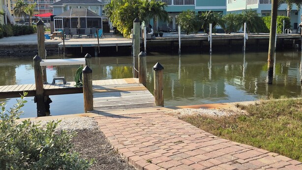 A waterfront property with a dock, a covered seating area, and a view of the water. - I'm the ONE! The CONCH Walk to Beach and Times Square (FMB)
