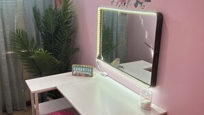 A pink-themed vanity area with a mirror, vanity table, and stools. - Quality in Town, Hot Tub Great Reviews!CLEAN! Comfy Beds Photo wall Game room  (Ellicottville)