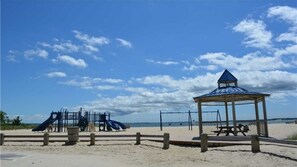 A beach with a playground, including slides and a gazebo. - Beautiful Colonial Mint Condition Summer House Walking Distance to Beach (Jamesport)