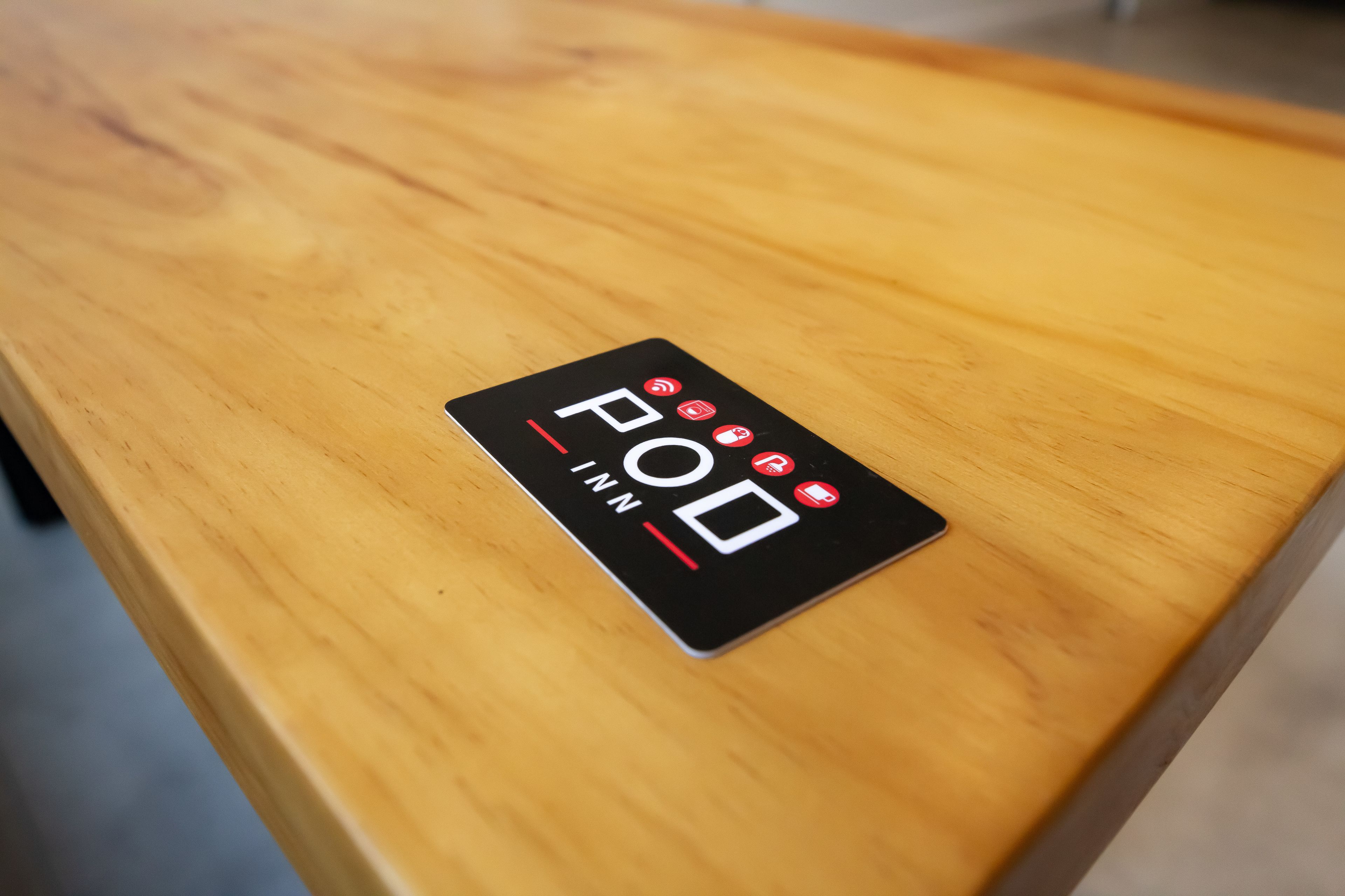 Een houten tafel met een zwart bord waarop staat 'FOD INN'.