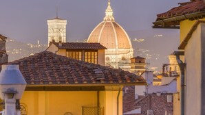 A historic building with a dome and a bell tower, surrounded by traditional architecture.