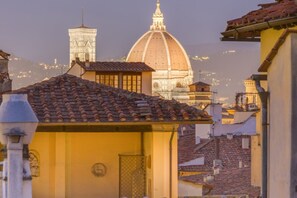 A historic building with a dome and a bell tower, surrounded by traditional architecture.