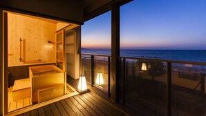 A wooden deck with a view of the ocean at dusk. - Yusai Resort HIBIKI (Kyotango)