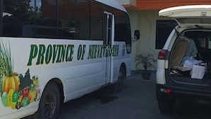 A white bus with "Province of Nueva Vizcaya" and a fruit illustration parked in front of the Tondaligan Beach Hotel. - Tondaligan Beach Hotel (Dagupan)