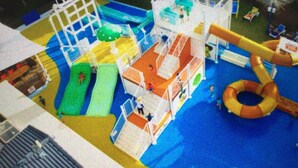 A water park with slides, a wave pool, and a ring toss game. - Gold Coast Family Apartment (Mermaid Beach)