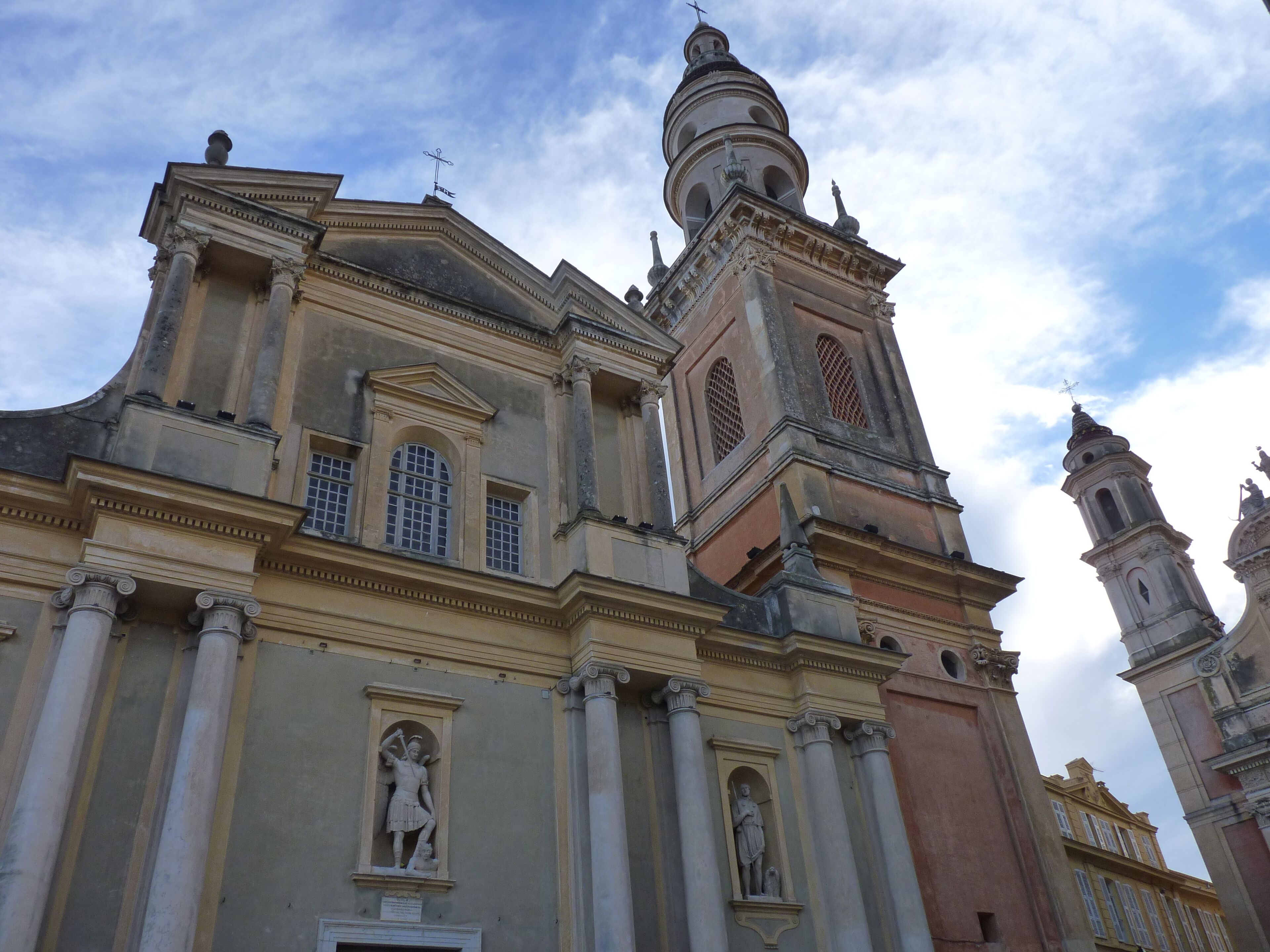 A historic building with classical architecture, including columns and statues.