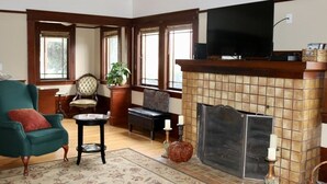 A cozy living room with a fireplace, a television, and comfortable seating.