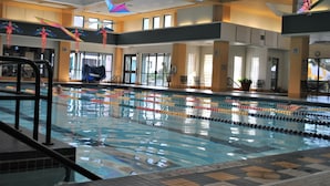 An indoor swimming pool with lane dividers, a diving platform, and colorful decorations. - SUN CITY GEORGETOWN, TX RESORT - STUNNING CONTEMPORARY! (Georgetown)