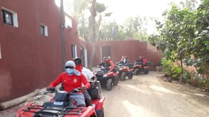 A group of people riding ATVs on a dirt road. - Grazia Maria Hotel (Mbour)