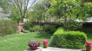 A well-maintained garden with a variety of plants and a wooden fence.