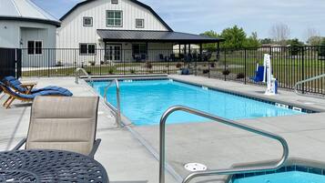 Seasonal outdoor pool, open 10:00 AM to 6:00 PM, pool umbrellas
