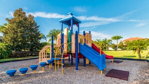 A playground with a slide, climbing structures, and a covered play area. - Fv53300 - Paradise Palms - 4 Bed 3 Baths Townhome (Kissimmee)