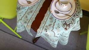 A small table with a lace tablecloth and two teapots with cups and saucers. - Ark-otel is not a hotel, but flat in an apartment building with 7 rooms.  (Gyor)