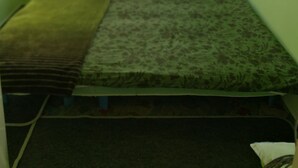 A small, single-bed room with a window, a radiator, and a green wall. - Ark-otel is not a hotel, but flat in an apartment building with 7 rooms.  (Gyor)