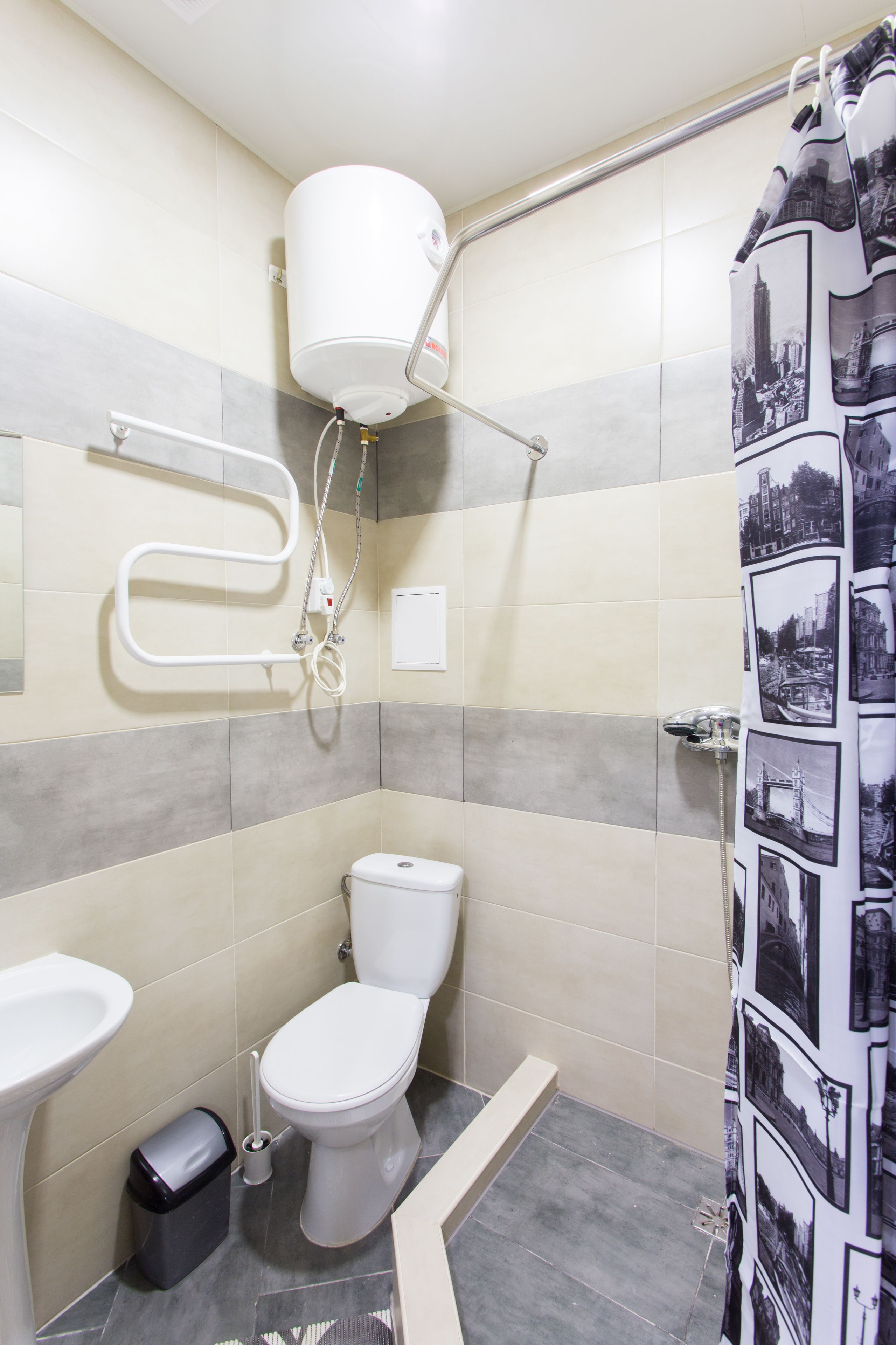 A bathroom with a toilet, sink, and shower.
