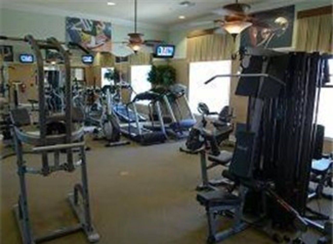A gym with various exercise equipment, including treadmills and weight machines.