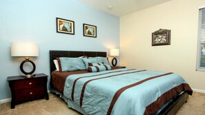 A bedroom with a bed, two bedside tables, and a nightstand. - Wh2608 - Windsor Hills Resort - 6 Bed 4 Baths Villa (Kissimmee)