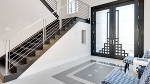 A modern interior with a staircase, a large sliding door, and patterned furniture. - Je52232 - Reunion Resort - 11 Bed 10 Baths Villa (Kissimmee)
