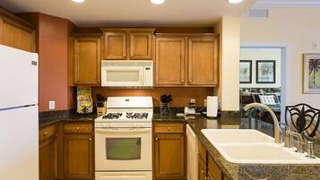 Family Condo, Balcony, Garden Area | Shared kitchen | Fridge, microwave, oven