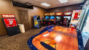 A room with arcade games, a ping pong table, and a trash bin. - Je58447 - Reunion Resort - 3 Bed 2 Baths Condo (Kissimmee)