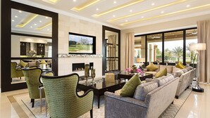 A modern living room with a sofa, chairs, a TV, and a fireplace. - Je58859 - Reunion Resort - 8 Bed 8 Baths Villa (Kissimmee)