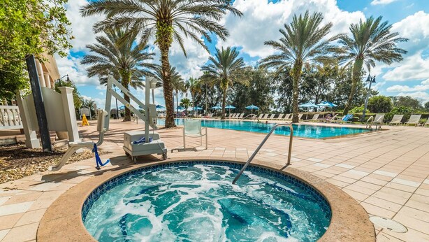 A hot tub surrounded by palm trees and lounge chairs. - Je62429 - Reunion Resort - 8 Bed 8 Baths Villa (Kissimmee)
