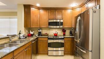 Family Condo, Balcony, Garden Area | Shared kitchen | Fridge, microwave, oven