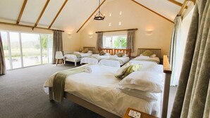 A hotel room with two beds, a large window, and a view of the outdoors. - The Victorian Barn self catering holidays with pool & hot tubs (Blandford Forum)