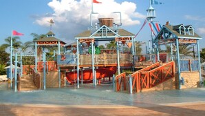 A water park with a large water slide, multiple play structures, and a central tower. - Je47048 - Reunion Resort - 4 Bed 4 Baths Villa (Kissimmee)