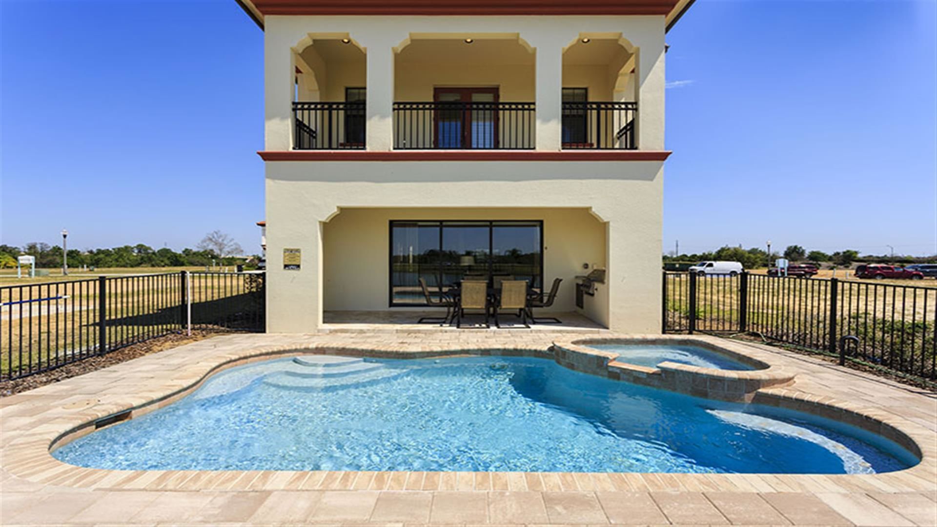 A two-story building with a swimming pool in front.