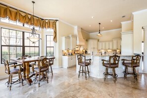 Enjoy cooking in this well-equipped kitchen with a central island, ample counter space, and dining area.