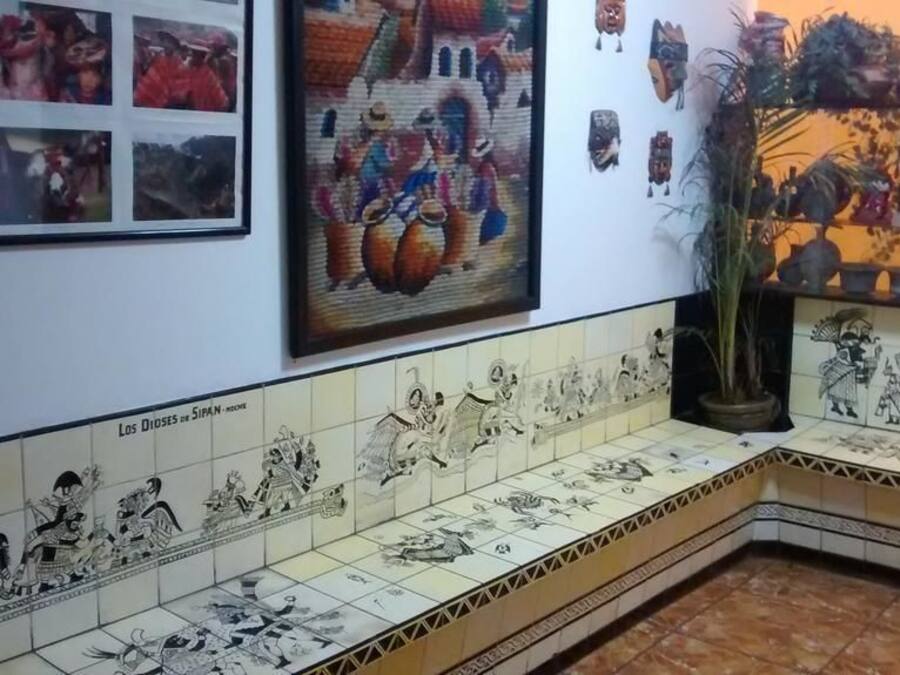 A tiled bench with a mural depicting historical figures and scenes.