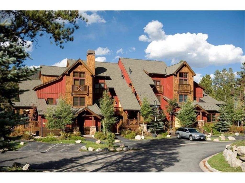 A large, multi-story lodge with a steeply pitched roof and wooden exterior.