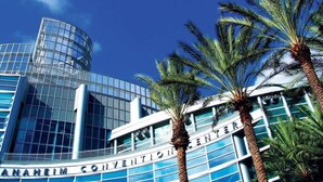 A modern building with a curved glass facade and the words "ANANHEIM CONVENTION CENTER" on the side. - Waking up in your own 3BR beach home!-C8 (Newport Beach)