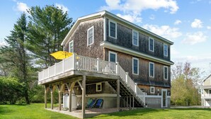 A two-story house with a covered porch and a staircase leading to the upper level. - 1 Block to Beach -large deck overlooking  beautiful  yard - Cul-de-sac (York)