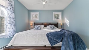 A bedroom with a bed, two bedside lamps, a ceiling fan, and a window with curtains. - 1 Block to Beach -large deck overlooking  beautiful  yard - Cul-de-sac (York)