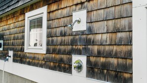 A house with wooden siding, a window, and two outdoor faucets. - 1 Block to Beach -large deck overlooking  beautiful  yard - Cul-de-sac (York)
