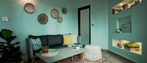 A living room with a sofa, coffee table, and decorative items.