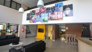 Un rebedor ampli amb un disseny modern, que destaca per una recepció, zona de seients i obra d'art a les parets.