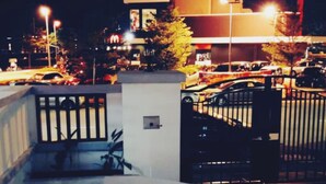 A nighttime view of a parking area with cars and a building in the background. - HomeStay Nimah Seaview (George Town)