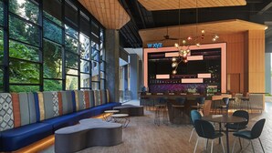 A modern bar area with a seating arrangement, large windows, and a wooden ceiling. - Aloft by Marriott Langkawi Pantai Tengah (Langkawi)