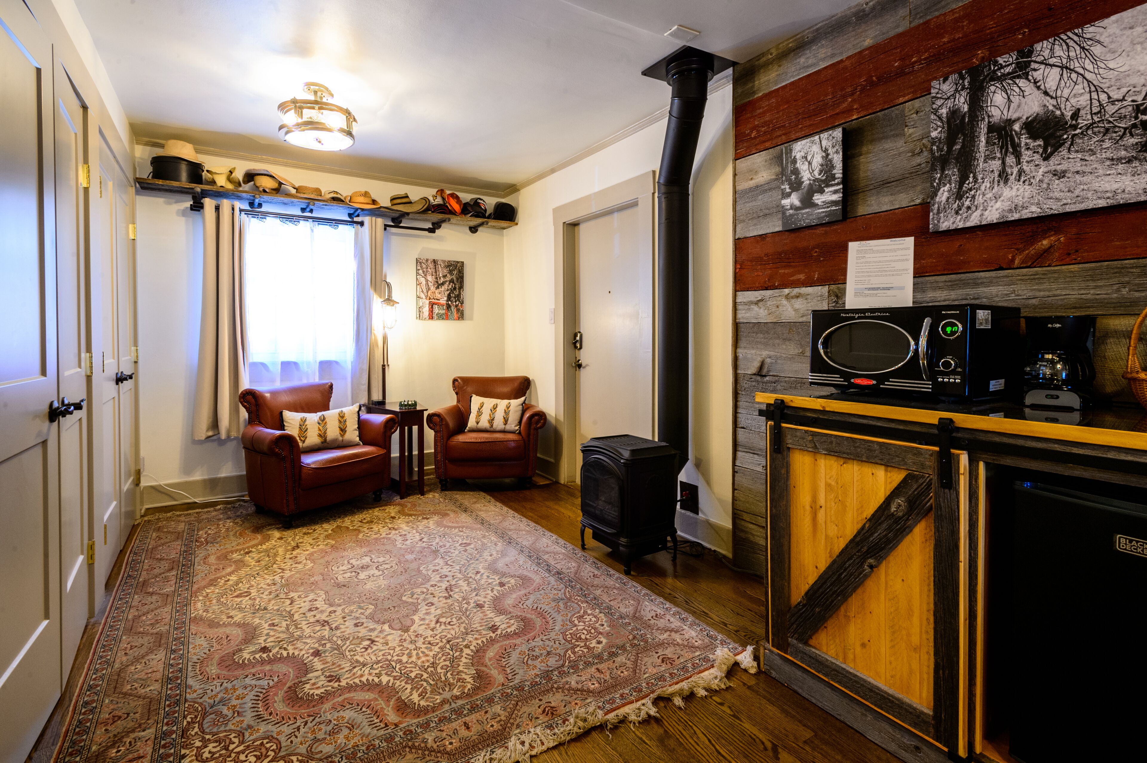 A cozy living room with a fireplace, a rug, and a television.