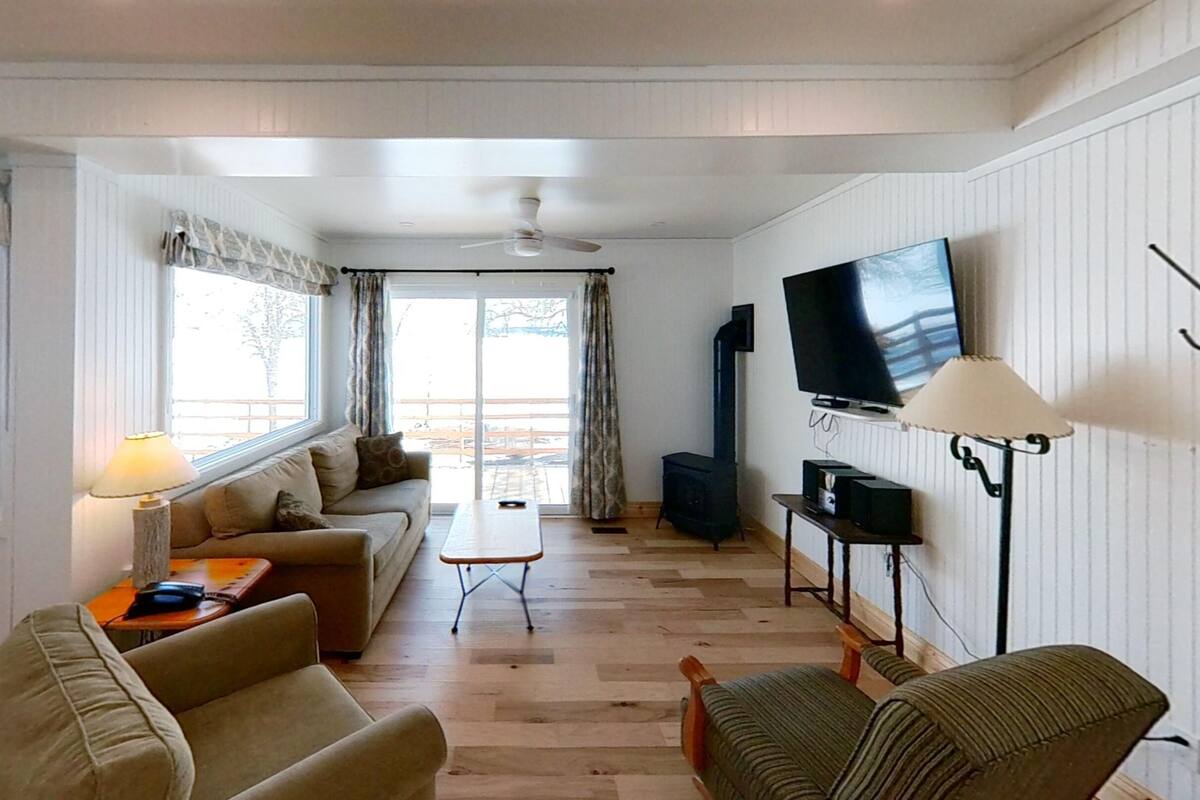 Una sala de estar acogedora con un sofá, una mesa de centro, un televisor y una chimenea.