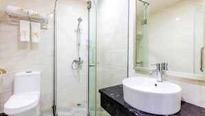 A modern bathroom with a glass-enclosed shower, a white sink, and a marble countertop. - Jinlizhou Hotel (Zhuhai)